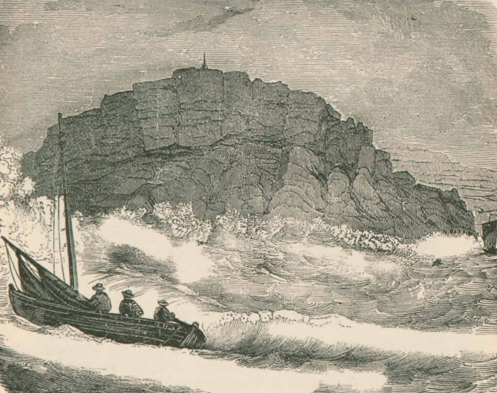 Men sailing a boat near a cliff in high waves at Saint Albans head
